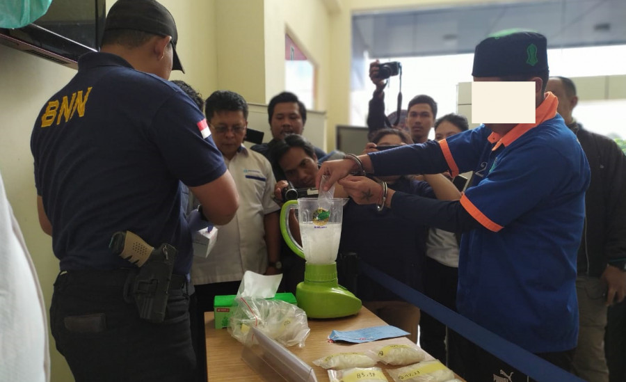 Tersangka DS saat melakukan pemusnahan barang bukti miliknya berupa sabu dan pil ekstasi pada Kamis (14/11) tadi. (Foto: Nancy/korankaltimcom)