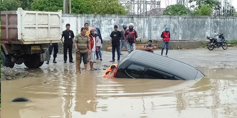 NYARIS TENGGELAM : Mobil avanza yang dikemudikan Wati masuk ke dalam parit d kawasan Stadion Balikpapan. Diduga sopir mengantuk sehingga kehilangan konsentrasi.