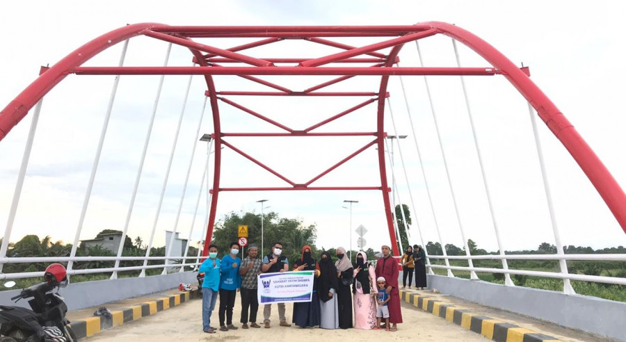 Camat Muara Wis, Arianto (tengah masker putih) saat melakukan aksi sosial di Jembatan Sebemban. (Foto: Kecamatan Muara Wis)